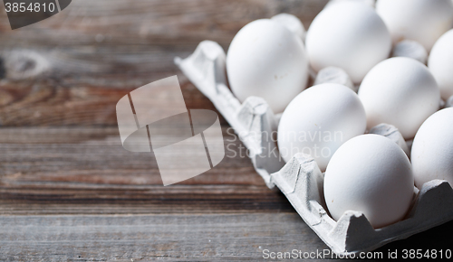 Image of White eggs on a rustic wooden table