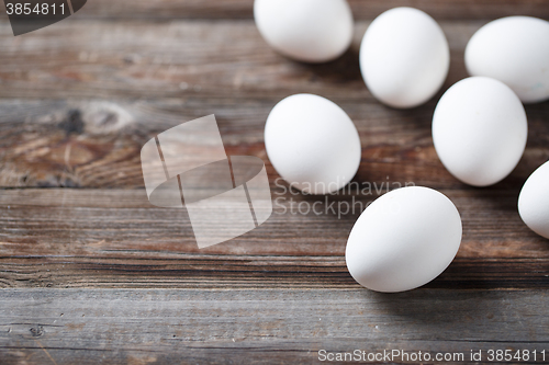 Image of White eggs on a rustic wooden table