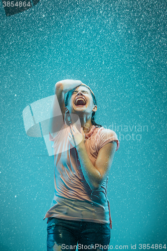 Image of The portrait of young beautiful woman in the rain