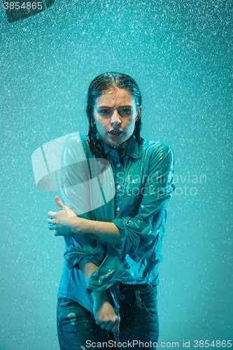 Image of The portrait of young beautiful woman in the rain