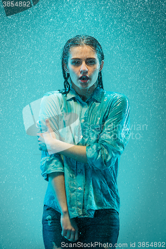 Image of The portrait of young beautiful woman in the rain