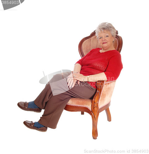 Image of Senior lady resting in armchair.