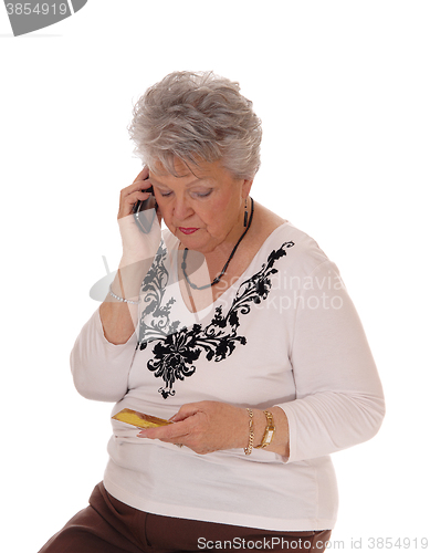 Image of Senior woman buying over phone.