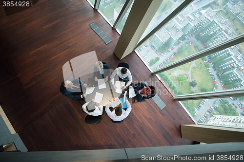 Image of happy business people group on meeting at modern office