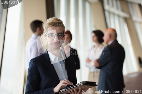 Image of portrait of older business woman  at office with tablet computer