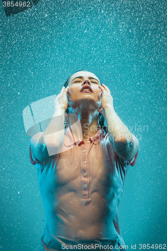 Image of The portrait of young beautiful woman in the rain