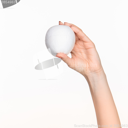 Image of The female hand holding white blank styrofoam oval 