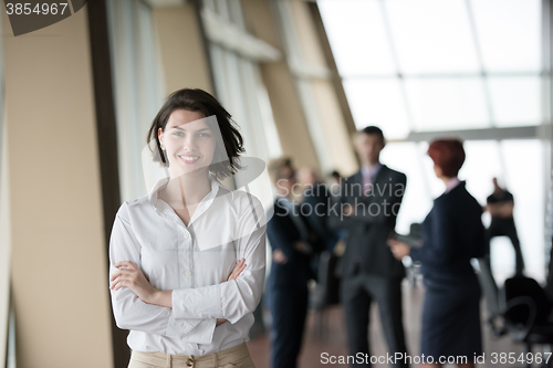 Image of young business woman in front her team