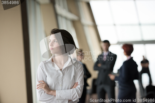 Image of young business woman in front her team