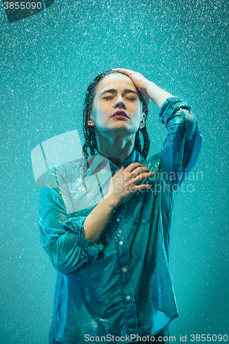 Image of The portrait of young beautiful woman in the rain