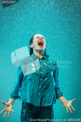 Image of The portrait of young beautiful woman in the rain