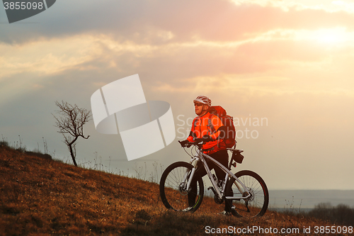 Image of Man cyclist with backpack riding the bicycle