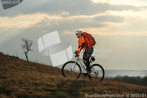 Image of Man cyclist with backpack riding the bicycle