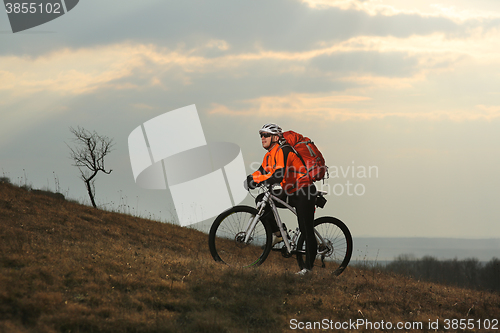 Image of Man cyclist with backpack riding the bicycle