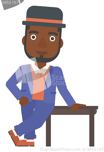 Image of Man leaning on table.
