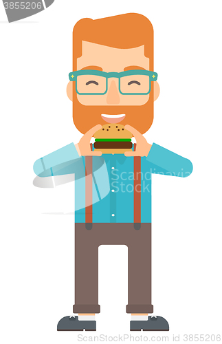 Image of Man eating hamburger. 