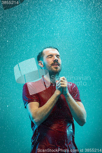 Image of The portrait of young man in the rain