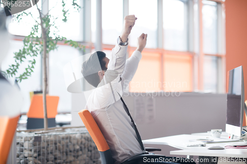 Image of young business man  working on desktop computer