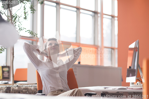 Image of happy young business woman relaxing and geting insiration