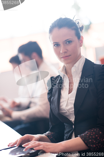 Image of business woman on meeting  using tablet