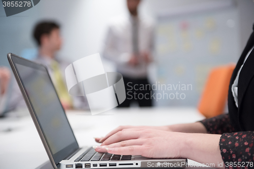 Image of young business woman on meeting  using laptop computer