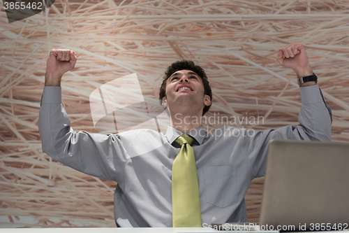 Image of young business man  working on laptop  computer at modern office