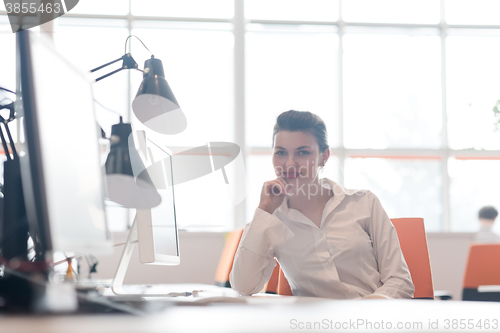 Image of business woman working on computer at office