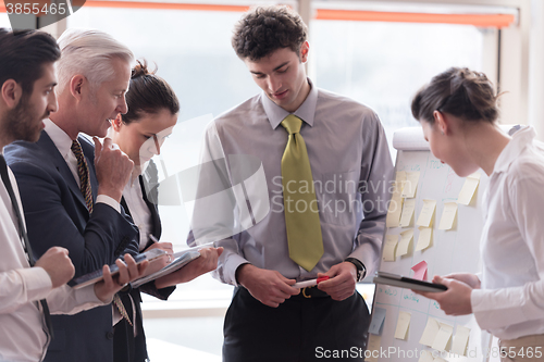 Image of young startup businessman making presentation to senior investio