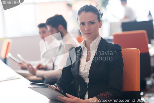 Image of business woman on meeting  using tablet