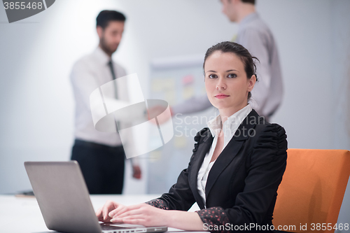 Image of young business woman on meeting  using laptop computer