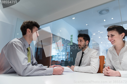 Image of young couple signing contract documents on partners back