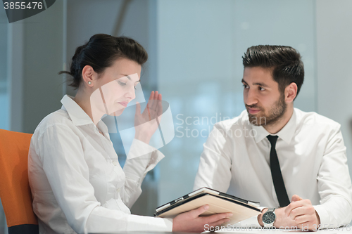 Image of young business couple working together on project