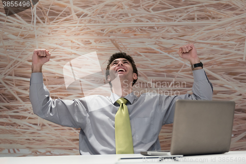 Image of young business man  working on laptop  computer at modern office