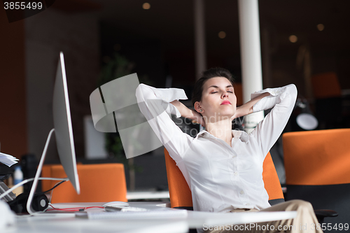 Image of happy young business woman relaxing and geting insiration