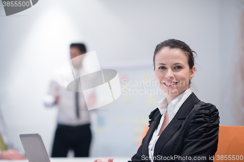 Image of young business woman on meeting  using laptop computer