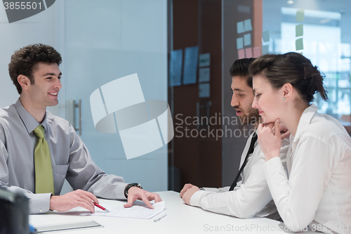 Image of young couple signing contract documents on partners back