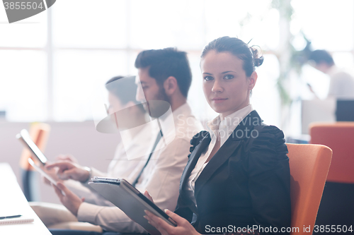 Image of business woman on meeting  using tablet