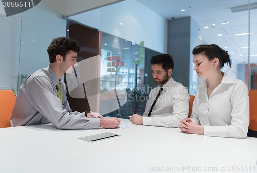 Image of young couple signing contract documents on partners back