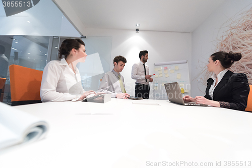 Image of business people group brainstorming and taking notes to flip boa