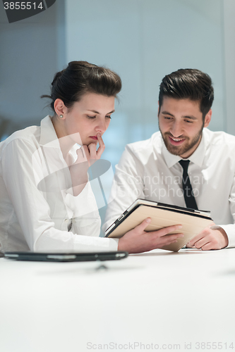 Image of young business couple working together on project