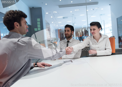 Image of young couple signing contract documents on partners back