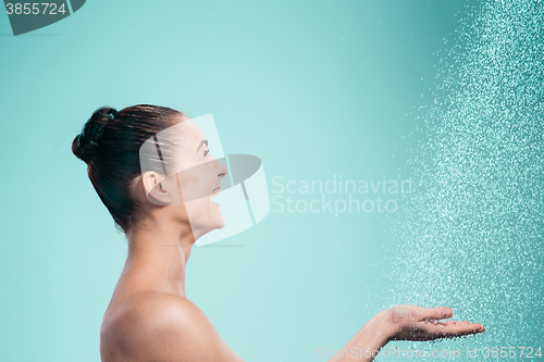 Image of Woman enjoying water in the shower under a jet