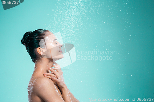 Image of Woman enjoying water in the shower under a jet