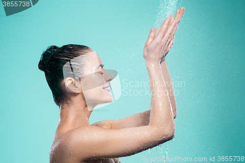 Image of Woman enjoying water in the shower under a jet