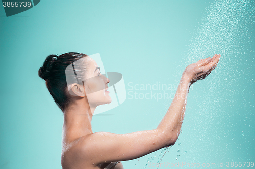 Image of Woman enjoying water in the shower under a jet