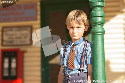 Image of boy in front of shop