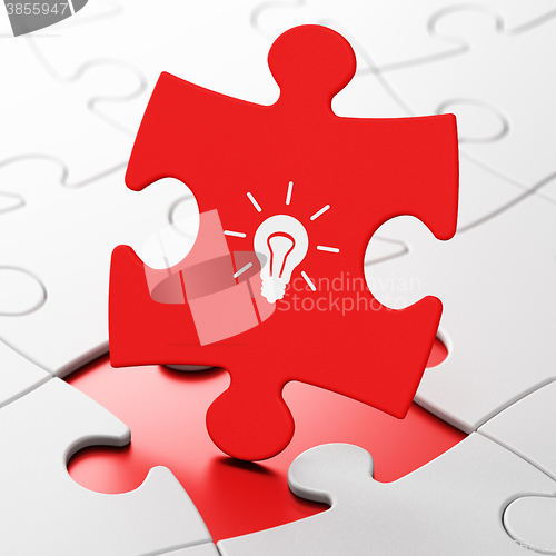 Image of Business concept: Light Bulb on puzzle background