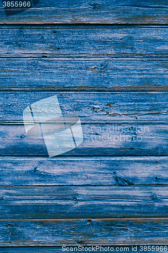 Image of Old blue cracked paint on wooden background