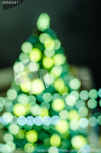 Image of Decorated Christmas tree. Abstract blurred lights background