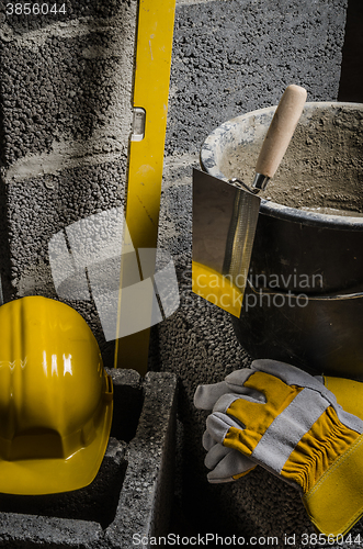 Image of Tools for bricklayer bucket with a solution and a trowel